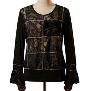 May include: Black long-sleeve top with a round neckline. The top features a patchwork design on the front with floral and lace patterns. The sleeves have flared cuffs with lace trim. The top is displayed on a mannequin.