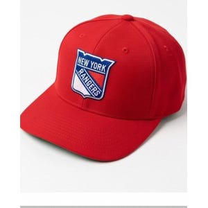 May include: A bright red baseball cap featuring an embroidered New York Rangers shield logo on the front. The logo includes the text New York Rangers in blue and white lettering against a red, white, and blue shield background with eyelets.