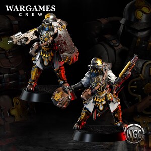 May include: Two miniature figures of armored soldiers. The figures are painted in black, gold, white, and red. One figure holds a pistol, and the other holds a rifle. The figures are on black bases. The text "WARGAMES CREW" is at the top.