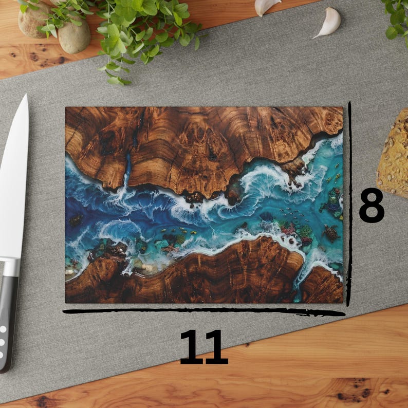 Tempered glass cutting board with flat printed faux ocean epoxy resin and burl wood illusion perfect for coastal charcuterie tray and kitchen decor