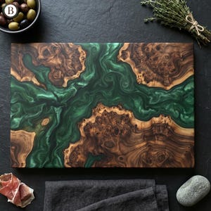 May include: A rectangular wooden cutting board with a river of green epoxy resin. The wood has a natural grain pattern with shades of brown and tan. The resin flows through the center, creating a unique and artistic design. A stylish kitchen accessory.