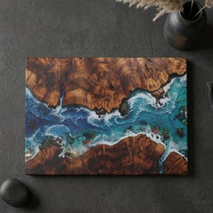 Tempered glass cutting board with flat printed faux ocean epoxy resin and burl wood illusion perfect for coastal charcuterie tray and kitchen decor