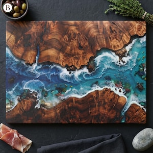 Tempered glass cutting board with flat printed faux ocean epoxy resin and burl wood illusion perfect for coastal charcuterie tray and kitchen decor