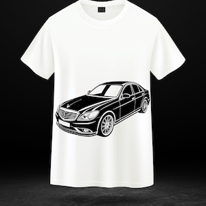 May include: White t-shirt featuring a black graphic of a luxury sedan. The car illustration is detailed, showcasing the vehicle's headlights, grille, and wheels. The shirt is made of a soft material.