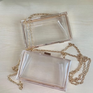 Clear acrylic cross-body clutch with gold chain