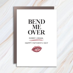May include: A white Father's Day greeting card with the text "BEND ME OVER" in black, followed by "SORRY I MEAN." and "HAPPY FATHER'S DAY." A red lip print is at the bottom. The card has a brown border.