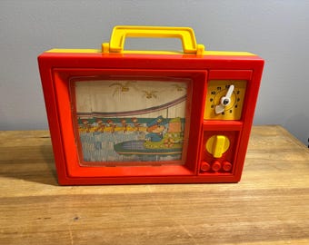 Vintage 1979 Blue Box wind-up musical toy television with moving screen