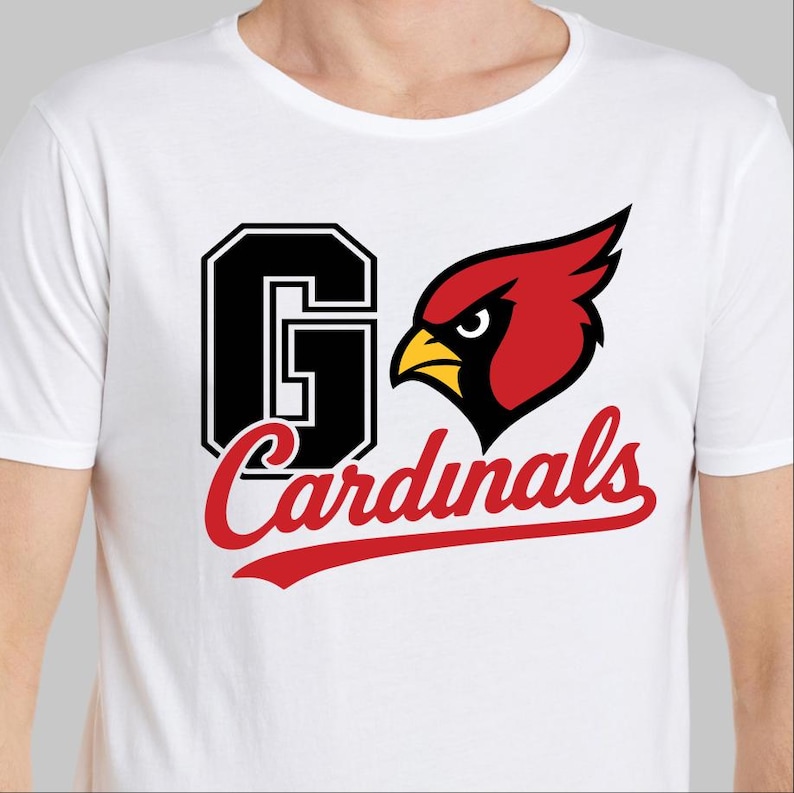 May include: White t-shirt featuring a graphic design with the text "Go Cardinals". The design includes a large black "G" with a white outline, a red cardinal bird, and the word "Cardinals" in red script.