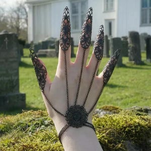 May include: A set of three ceramic mugs with a speckled, cream-colored glaze. Each mug features a different hand-painted floral design in shades of blue, green, and yellow. The mugs have a simple, rounded shape and a comfortable handle.