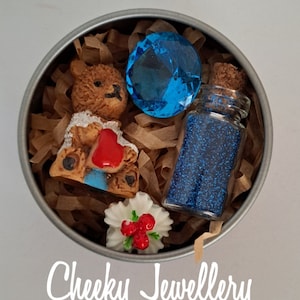 Mini bear adoption kit in tin, with adoption certificate.