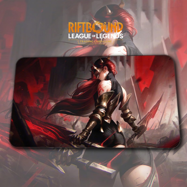 May include: A rectangular mousepad featuring a warrior with red hair and gold armor, holding two swords. The background is a dark, dramatic scene with red accents. The text "RIFTBOUND LEAGUE OF LEGENDS TRADING CARDS" is at the top.