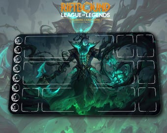 May include: A rectangular playmat for the League of Legends trading card game. The mat features a teal and black illustration of a character with glowing accents. The top of the mat has the text "RIFTBOUND LEAGUE OF LEGENDS TRADING CARD GAME". The mat has numbered zones.