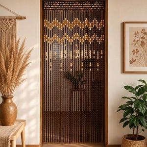 May include: A beaded door curtain featuring vertical strands of dark brown wooden beads. The upper section displays a repeating chevron pattern in alternating shades of light tan, cream, and dark brown, with occasional light-coloured accent beads.