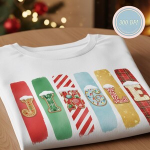 May include: White sweatshirt with the word "JOYFUL" spelled out in colorful, festive designs. Each letter is a gingerbread cookie on a painted brushstroke, with snow accents. The design is perfect for the holiday season.