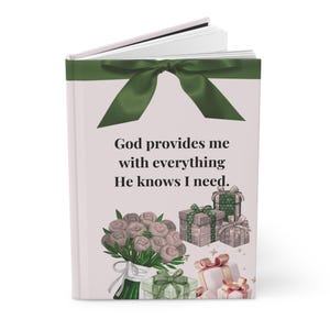 May include: A hardcover journal with a green ribbon and the text "God provides me with everything He knows I need." The journal features illustrations of a bouquet of flowers and wrapped gifts.