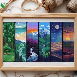 May include: A framed pixel art landscape with six vertical panels, each showing a different scene: forests, rivers, mountains, and sunsets. The artwork is in a light wooden frame. The artist's name is in the top left corner.
