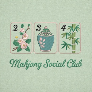 May include: A white ceramic mug with a black handle and the text "But First, Coffee" in a bold, black font. The mug is set against a blurred background, suggesting a cosy setting.