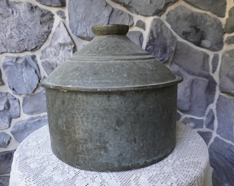 A large beautifully hammered copper pot