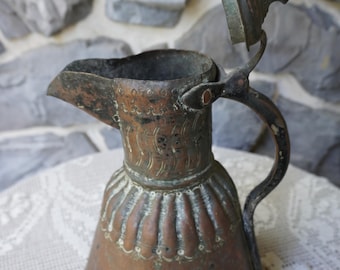 An antique copper pitcher or ewer, likely from the 19th century, in Egypt