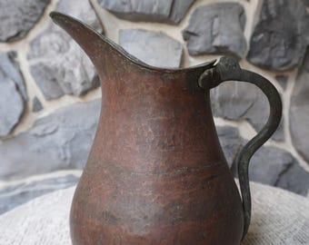 One of a kind hammered antique copper pitcher from Egypt.