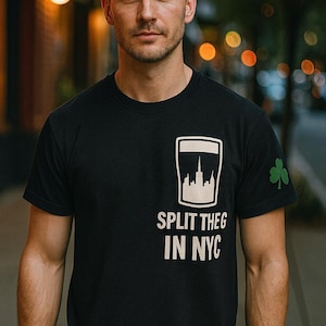 May include: Black crew neck t-shirt with a white cityscape graphic and the text "SPLIT THEG IN NYC". A green shamrock is on the sleeve.