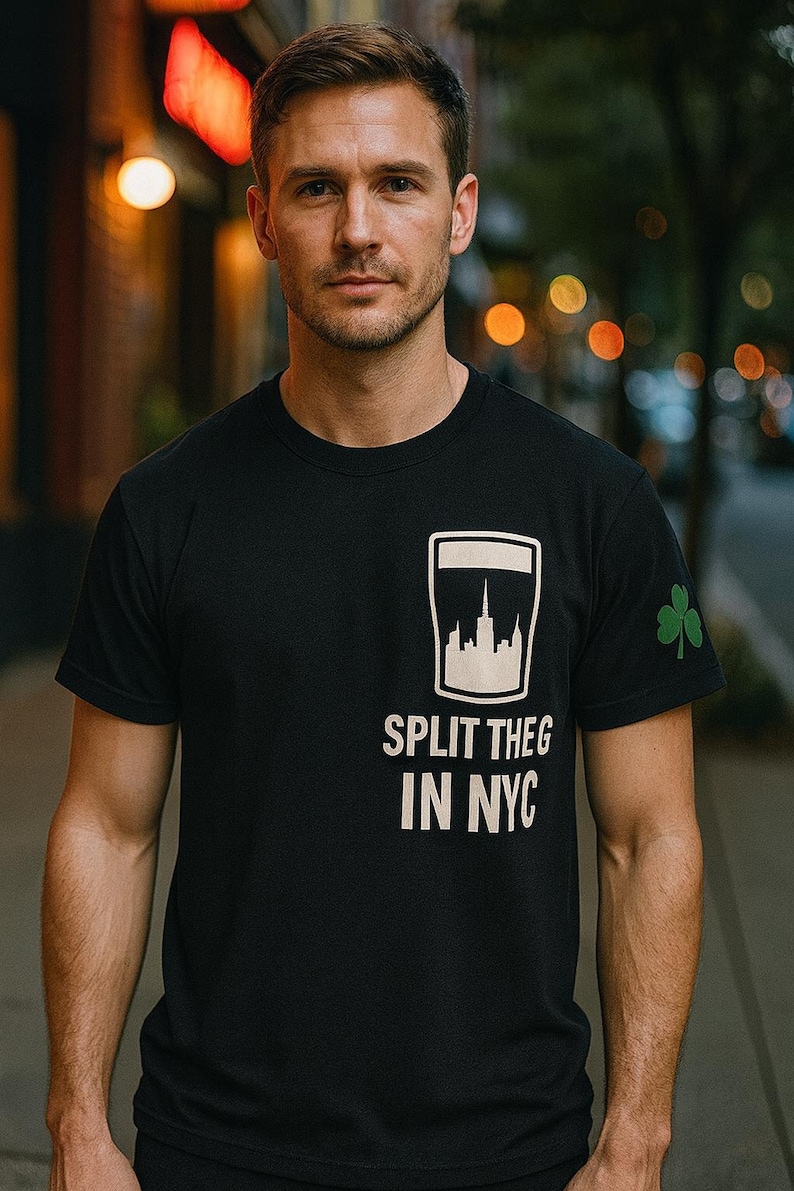 May include: Black crew neck t-shirt with a white cityscape graphic and the text "SPLIT THEG IN NYC". A green shamrock is on the sleeve.