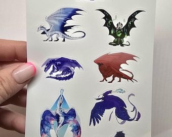May include: A sheet of stickers featuring nine different dragon designs. The dragons are depicted in various poses and colours, including blue, green, red, purple, and white. The stickers are perfect for adding a touch of fantasy to laptops, water bottles, or journals.
