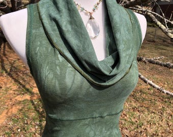 May include: A green sleeveless top with a cowl neck and a tie-dye pattern. The top is made of a soft, comfortable fabric and has a relaxed fit.