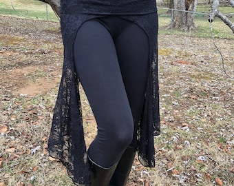 May include: Black leggings with a black lace overlay skirt. The skirt has a slit at the front and is gathered at the waist.