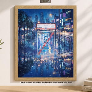 May include: A framed print featuring a vibrant, rainy cityscape with reflections on the wet pavement. The artwork includes a trading card with text and a display vault logo. The frame is made of light-colored wood. The text on the print says "Cards are not included only comes with frame and print."
