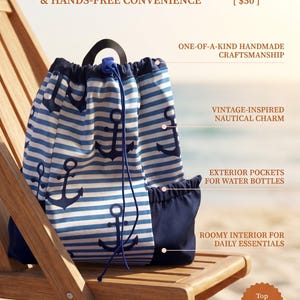 May include: A drawstring backpack featuring a blue and white horizontal striped pattern with dark blue anchor motifs. The bag includes a solid dark blue base, side pockets, a black top handle, and a blue cord closure with a plastic toggle.