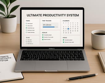 May include: A laptop displaying the "ULTIMATE PRODUCTIVITY SYSTEM" interface, with a notebook and pen nearby. A cup of coffee and a small plant are also on the wooden desk. The laptop screen shows a time tracker and calendar.