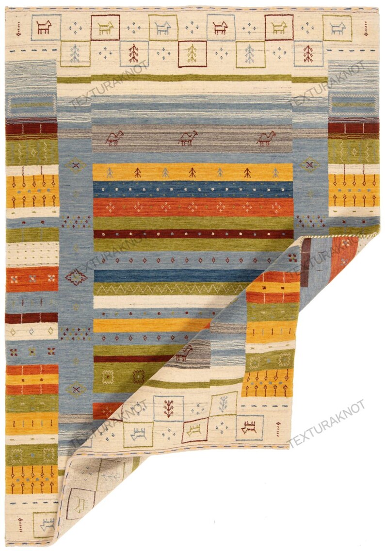 May include: A rectangular, hand-woven rug with a geometric design. The rug features a light beige background with blue, yellow, orange, and green stripes and borders. Decorative animal and tree motifs are incorporated throughout the design.