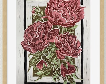 May include: A framed floral print featuring a bouquet of peonies in shades of burgundy and green. The flowers are set against a brown and white background with a black border, all within a light wood frame. The artwork has a linocut style.
