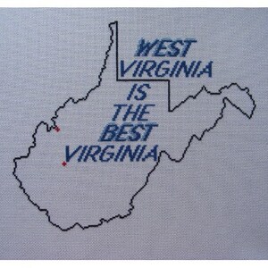 May include: A cross-stitch design of the state of West Virginia with the text "West Virginia is the best Virginia" in blue thread.