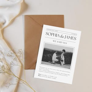 May include: A wedding invitation with the names "Sophia & James" in a newspaper-style design. The invitation includes a black and white photo of a couple and the text "We Said Yes". A brown envelope is behind the invitation.