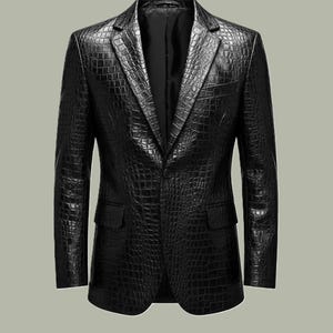 May include: A black blazer with a textured, crocodile-like pattern. The jacket has a notched lapel, two front pockets, and a single-button closure. The blazer is a classic style, suitable for formal or semi-formal occasions.