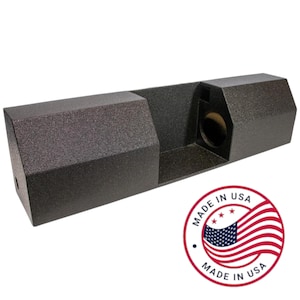May include: A black, textured rectangular audio speaker enclosure. The enclosure has a rectangular shape with a recessed section and a circular opening. The product is marked with a "Made in USA" sticker.