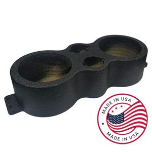 May include: Black plastic console organizer with three circular compartments and two smaller openings. The organizer has a textured surface and a mounting bracket on one side. The "Made in USA" logo is visible.
