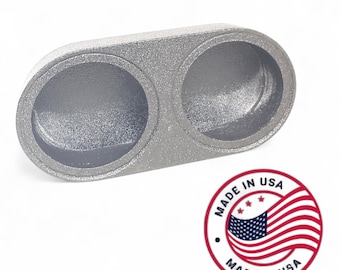 May include: A silver-colored, dual-port exhaust tip. The tip has two circular openings and a textured surface. A "Made in USA" emblem is visible in the lower right corner.