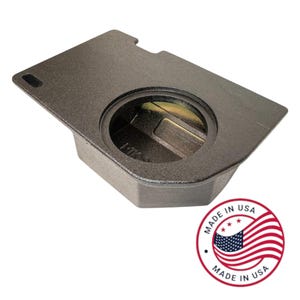 May include: A dark gray metal component with a circular opening and a rectangular slot. The component has a textured surface and a beveled edge. A "Made in USA" sticker is in the lower right corner.