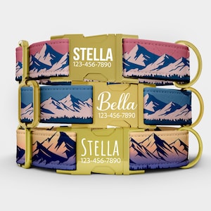 May include: Three dog collars with mountain range designs in pink, blue, and yellow. Each collar has a gold-colored buckle with a name and phone number. The names "Stella" and "Bella" are displayed.