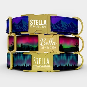 May include: Three personalized dog collars with gold-colored buckles. The collars feature a landscape design with mountains and aurora borealis in shades of blue, purple, pink, and green. Each collar displays a name and phone number.
