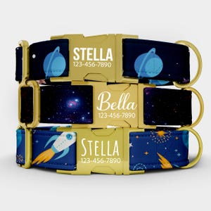 Peut inclure: Trois colliers personnalisés pour chiens avec boucles dorées. Les colliers présentent un motif sur le thème de l'espace bleu marine avec des planètes, des fusées et des étoiles. Chaque collier affiche un nom et un numéro de téléphone en texte blanc.