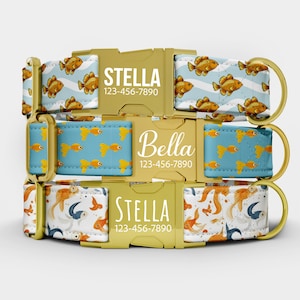 May include: Three dog collars with gold hardware and personalized text. The collars feature various patterns, including goldfish on blue and white backgrounds. Each collar has a name and phone number.
