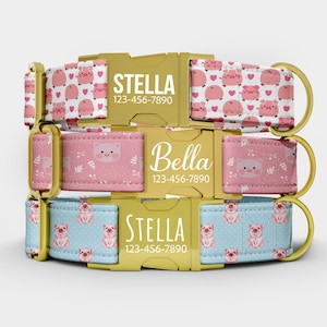 May include: Three personalized dog collars with gold-colored buckles. The collars feature pig patterns in pink and blue, with names and phone numbers printed on the buckles. The top collar has a white background with pink pigs and hearts.