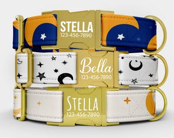 May include: Three personalized dog collars stacked on top of each other. The collars have gold-colored buckles and hardware. The top collar is navy blue with an orange crescent moon design. The middle collar is white with black stars and moons. The bottom collar is white with an orange sun design. Each collar has a name and phone number.