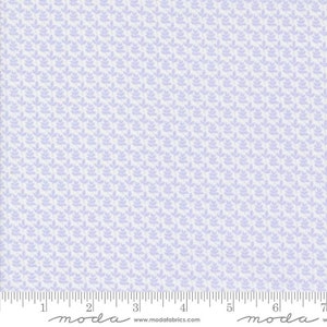 May include: A white fabric with a light purple repeating pattern of small leaves. The fabric is textured and has a subtle sheen. The fabric is marked with a ruler in inches and the words "moda" and "www.modafabrics.com".
