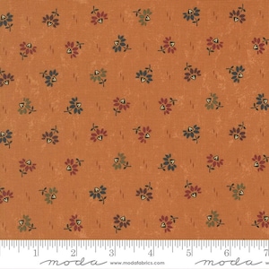 May include: Orange fabric with a repeating floral pattern. The flowers are in shades of blue, red, and green, with small leaves. The fabric has a textured appearance and a ruler at the bottom.