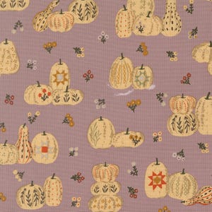 May include: A mauve fabric featuring a repeating pattern of cream-coloured pumpkins and gourds. The pumpkins are decorated with various line-drawn motifs, including geometric star shapes, floral sprigs, and vertical stripes, interspersed with small flower clusters.